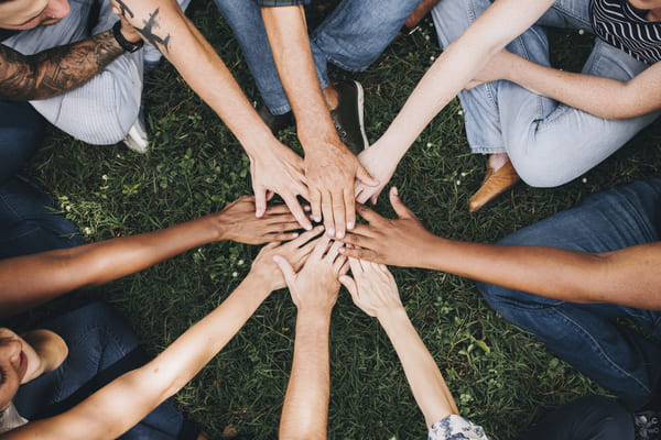 people-stacking-hands-together-park.jpg